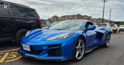 2025 Corvette E-Ray hybrid V8 sports car in motion with aggressive new design