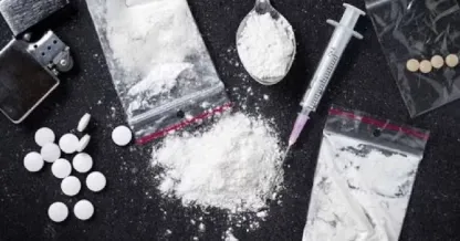Seized drugs: white powder, syringe, packets found by polic