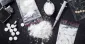 Seized drugs: white powder, syringe, packets found by polic